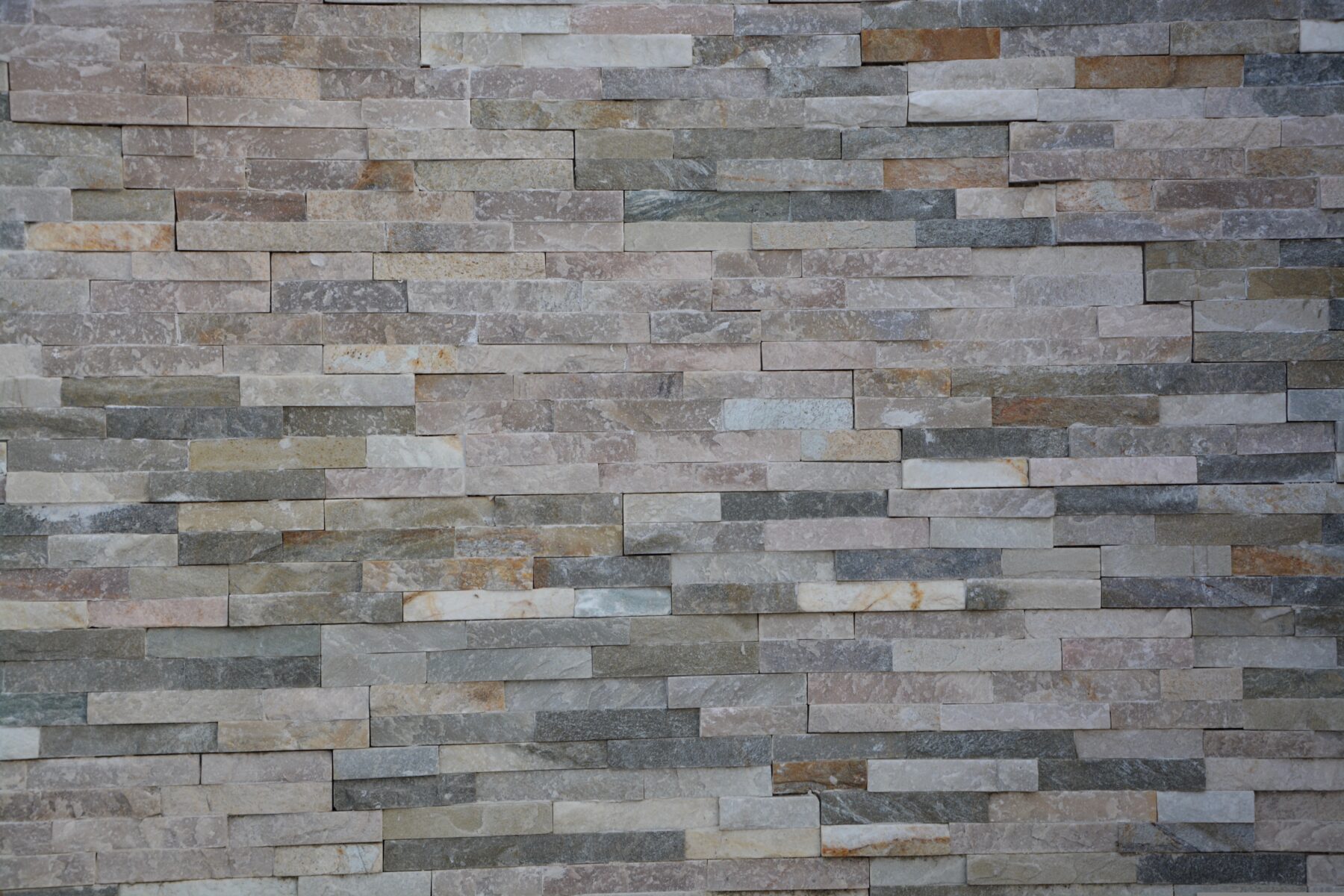 Close‑up of manufactured stone veneer wall showing texture and density that support freeze‑thaw durability in cold‑climate home exteriors.